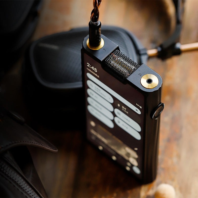 Shanling M8T top edge close-up with a headphone cable in the gold-plated 4.4mm balanced output